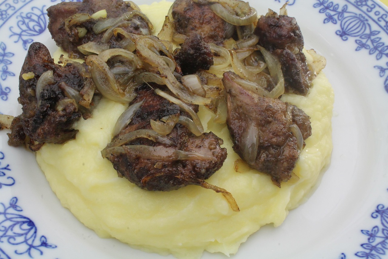 Fried Chicken Gizzards with Onions over Mashed Potatoes