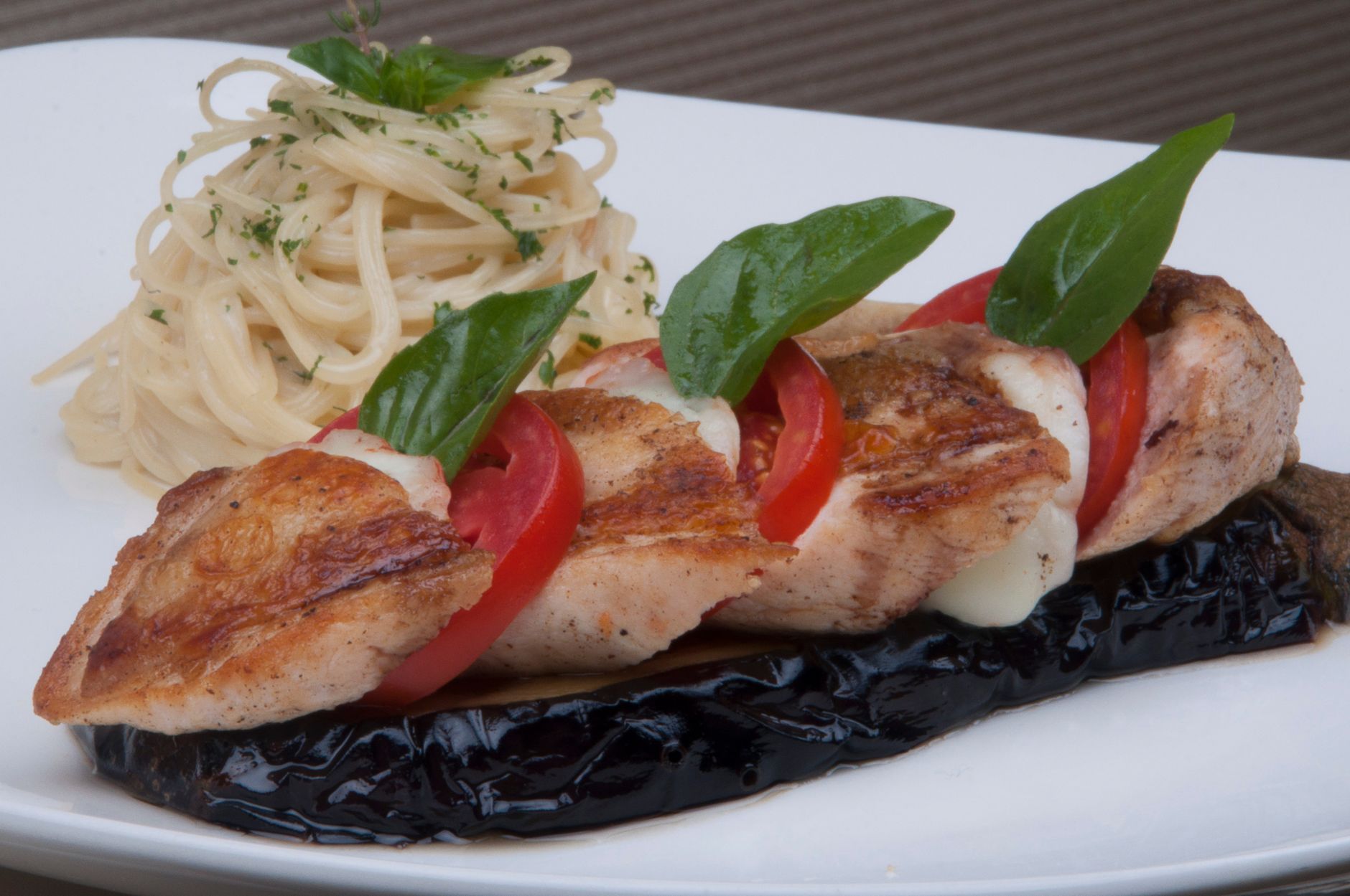 Grilled Chicken with Tomatoes and Basil on Eggplant