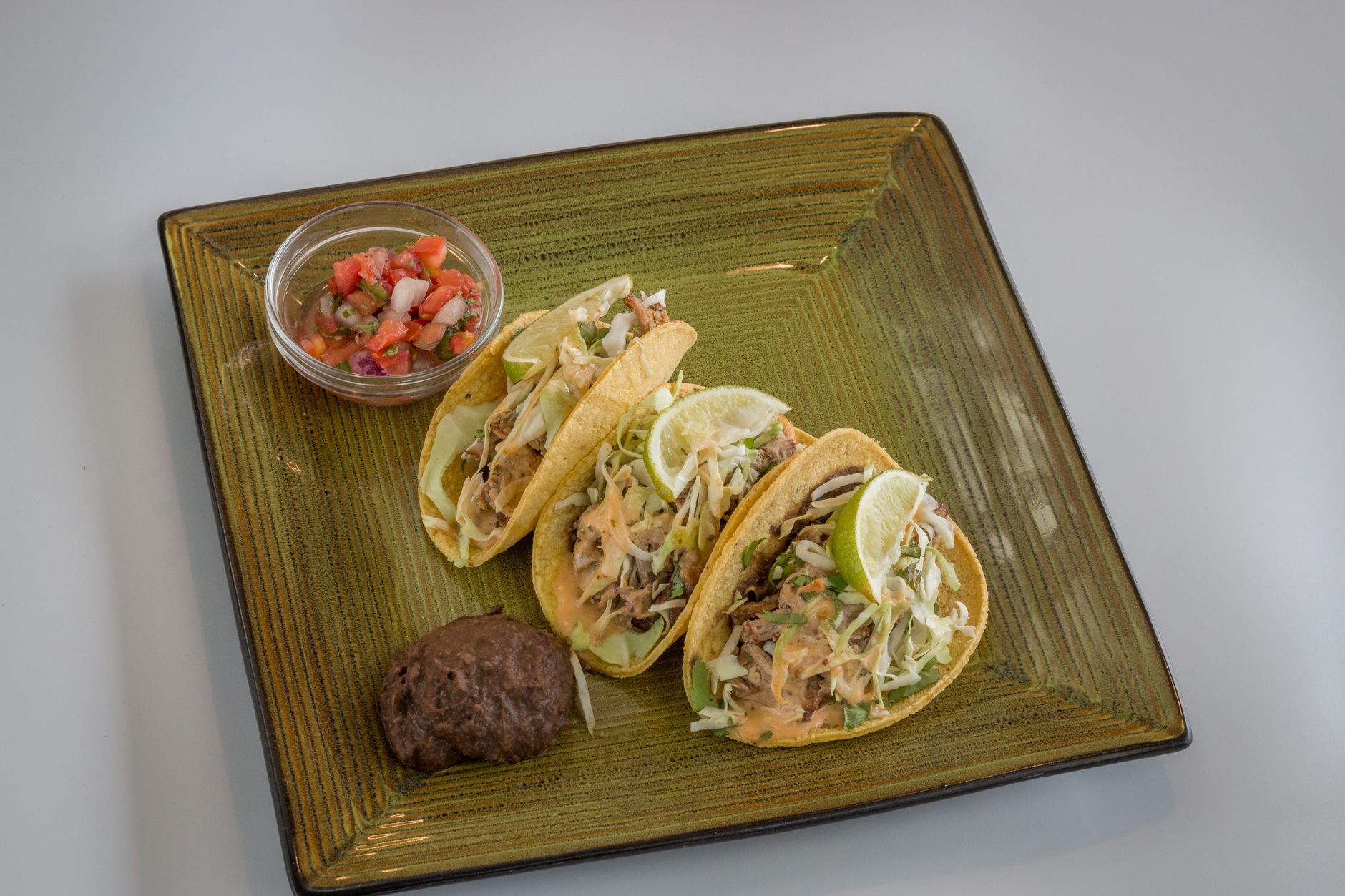 Crispy Pork Carnitas Tacos with Beans & Pico