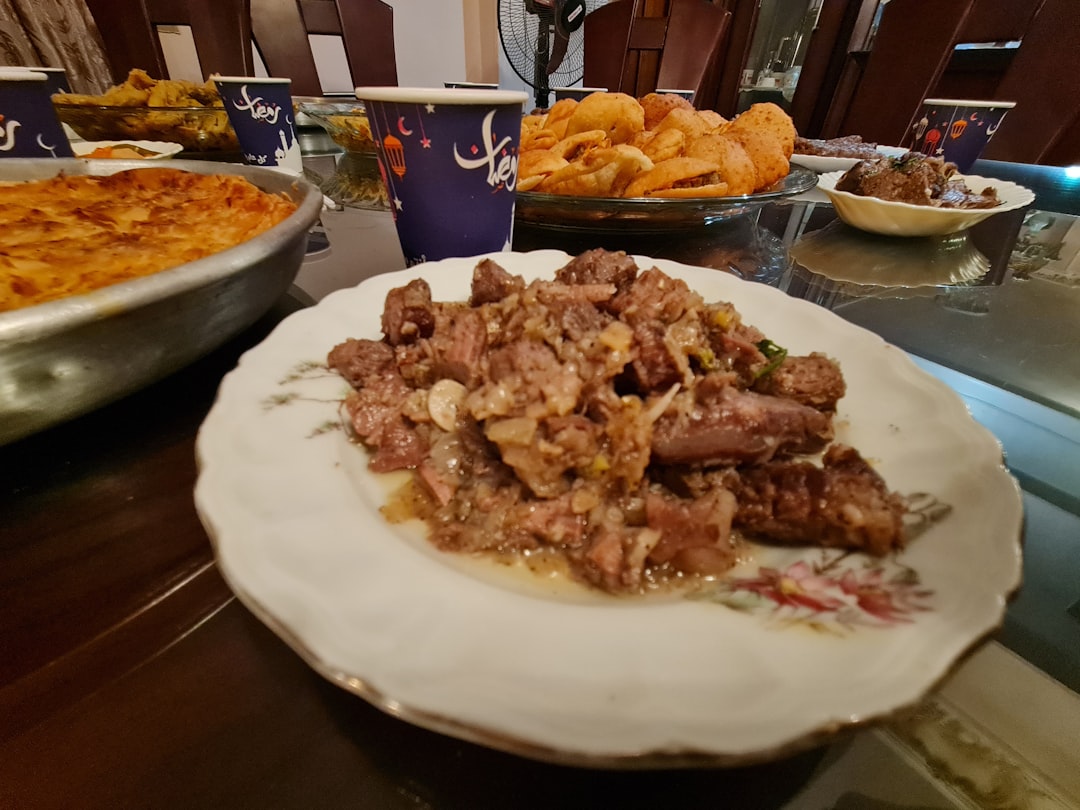 Peppered Grilled Lamb Asun with Jollof Rice & Puff Puff