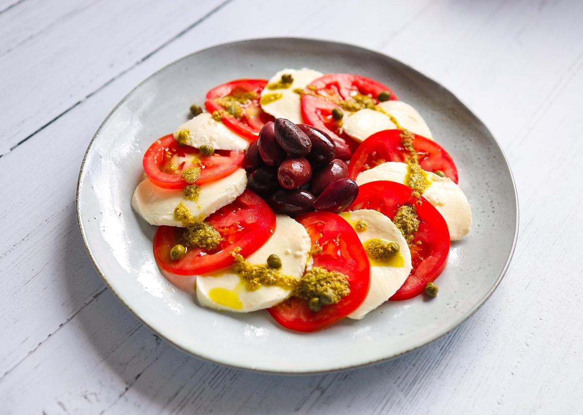 Caprese Salad with Black Olives and Pistachio Pesto
