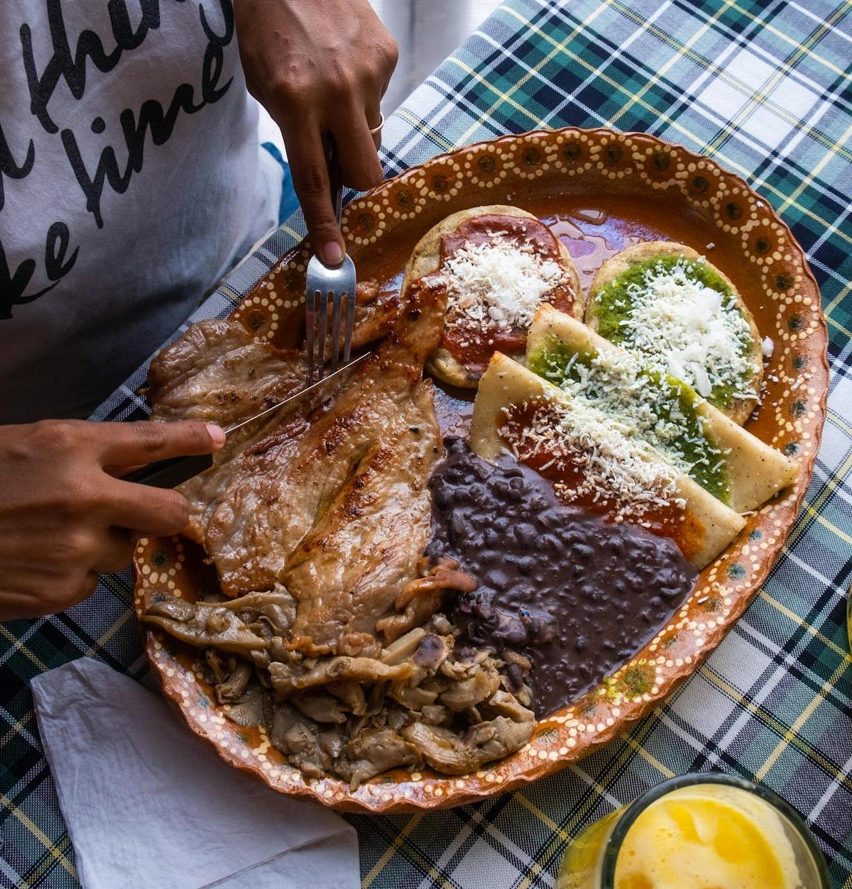 Crispy Pork Tlayudas with Beans & Cheese